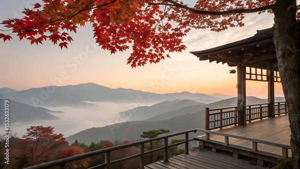 Obraz Traditional wooden terrace on the right side, overlooking a misty mountain valley at sunrise. Red maple leaves frame the top right corner, creating a serene and poetic autumn scene with soft pastel sk