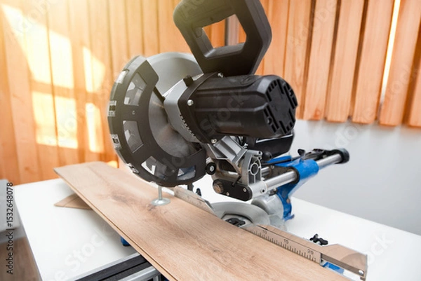 Fototapeta Miter saw while working on flooring panels