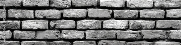 Obraz Monochrome close up of a textured brick wall with visible mortar and weathered surfaces in a pattern