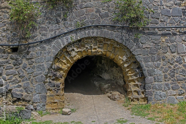 Obraz Oval dark entrance to the ancient cave outside