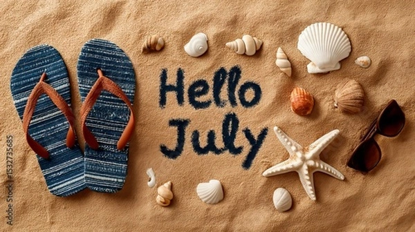 Fototapeta Flops, Sunglasses, and Seashells Arranged on Sand, with “Hello July” written in the center. The image evokes summer joy, travel, and seasonal celebration