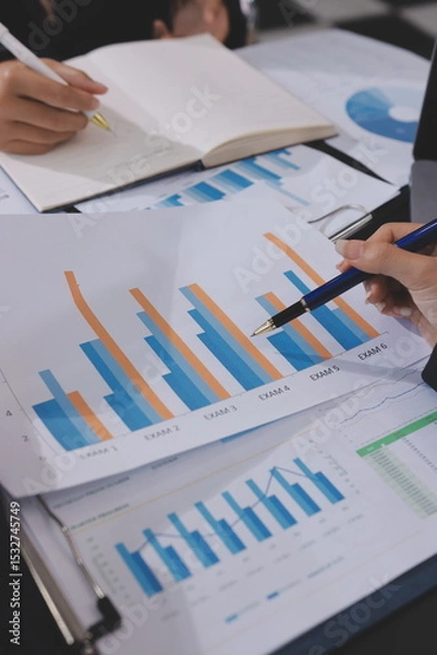 Fototapeta Team of business people working together in the meeting room office,
teamwork background charts and graphs banner, double exposure successful teamwork,business planning concept.