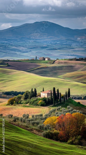 Obraz A scenic view of a house in a valley with trees and rolling hills under a cloudy sky in the countryside
