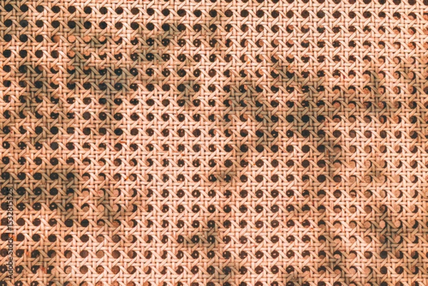 Fototapeta Rattan texture pattern with sunlight shadow from above. Summer beach aesthetic background. Natural minimal outdoor fashion design.