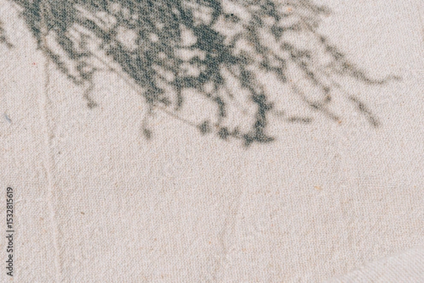 Fototapeta Beige natural cotton linen with lavender shadow and sunlight texture. Summer minimal aesthetic background for beauty and spa mockup template with empty space. Neutral boho style design flat lay.