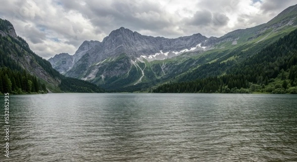 Fototapeta Mountain lake scene under a cloudy sky