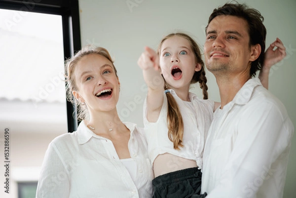 Obraz Family portrait consisting of father, mother and daughter.	