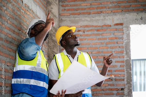 Obraz Construction engineers and foremen are inspecting the construction within a housing project.