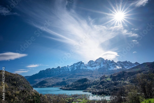 Fototapeta sun shining over Bubal reservoir, in Pueyo de Jaca with the snow-capped Pena Telera in the background, Pyrenean landscape in the Tena Valley in the Aragonese Pyrenees
