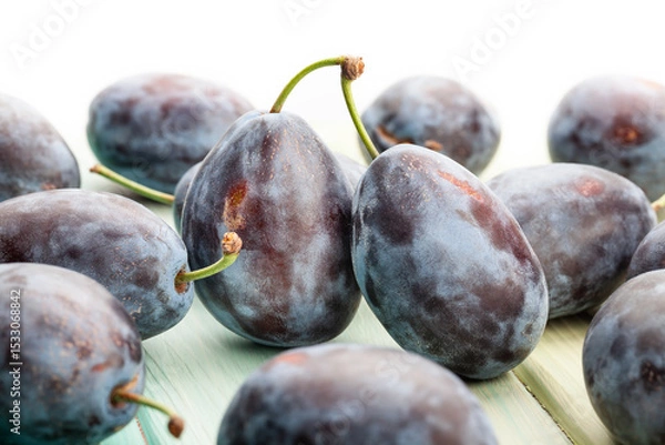 Fototapeta prune plum on wood background on white