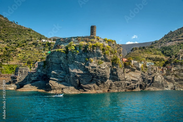 Fototapeta The seaside village on rocks of Monterosso al Mare, Cinque Terre, towers of a medieval fortress, and colorful houses nestled between terraced hills