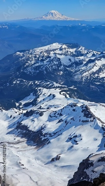 Obraz Snowy mountain peaks under a clear blue sky with a distant snow capped mountain in the background
