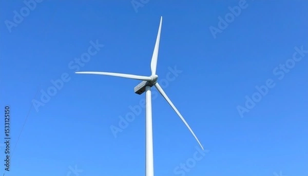 Fototapeta 鮮やかな青空を背景に低い位置から捉えられた風力タービンが、柔らかな昼光に照らされて回転するブレードの動きを美しく表現する


