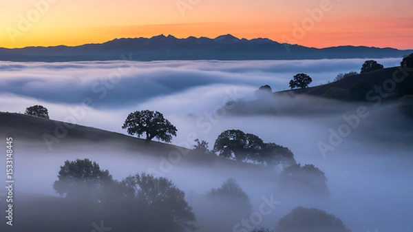 Fototapeta Misty Sunrise over Mountain Range and Rolling Hills