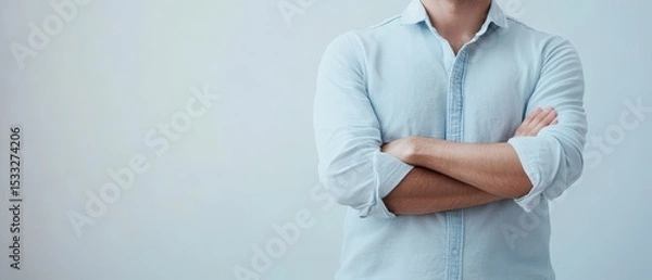 Fototapeta Person with crossed arms in relaxed pose indoors