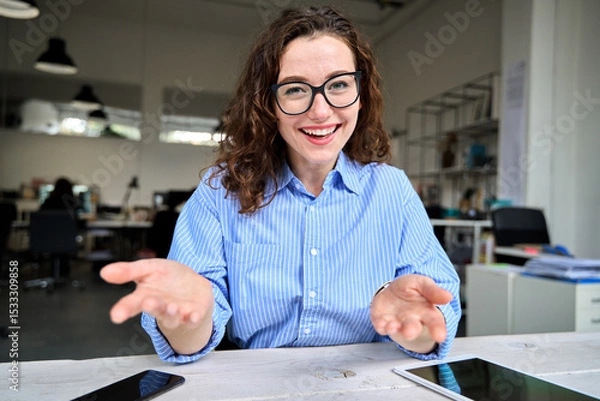 Obraz Web cam view of happy young business woman leader, coach, hr manager talking to web camera having online job interview, remote video conference call or leading work webinar sitting in office.