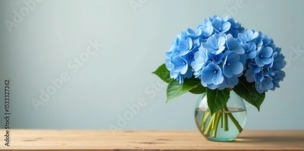 Fototapeta Elegant vase surrounded by lush blue hydrangeas, sitting on a simple wooden table , decoration, hydrangea