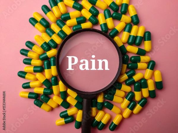 Fototapeta Top view medicine pill and magnifying glass with the word Pain on a pink background