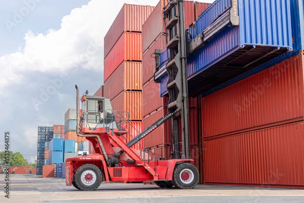 Fototapeta Logistics and Global Trade Container Yard Operations for Background Concept, Forklift Stacking Shipping Containers at Port Terminal