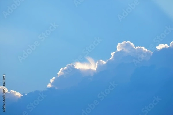 Fototapeta Soft Blue Sky with Gentle White Clouds and Sunlight Highlights