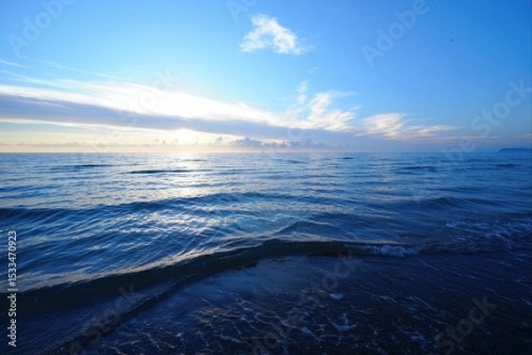 Fototapeta Serene Ocean View at Sunset with Clear Sky and Gentle Waves