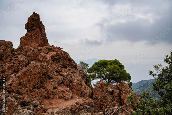 Fototapeta Volcanic Trail Through Jagged Lava Rocks in Methana