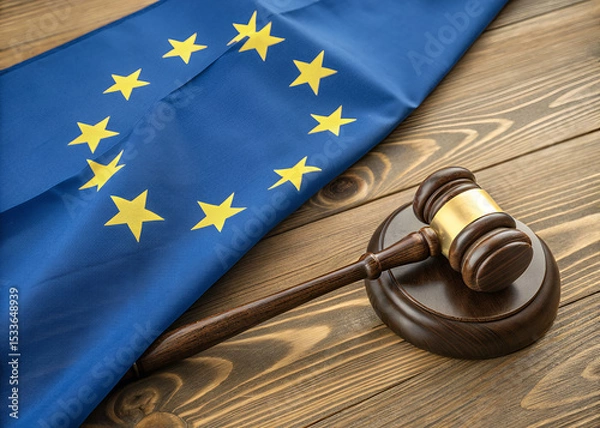 Obraz EU Law and Justice: A gavel rests upon a wooden base, with EU flag as backdrop, symbolizing the scales of justice, law, and order within the European Union.
