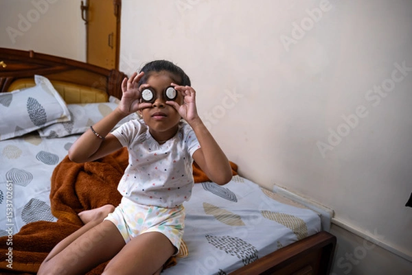 Obraz Child playing with cookies in cozy bedroom setting