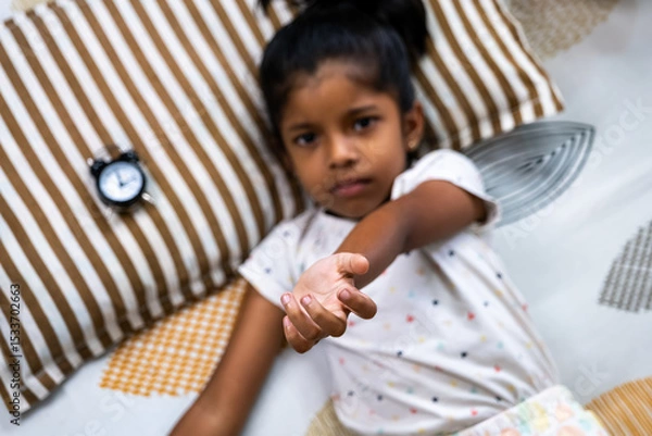 Obraz Child reaching out for help from a cozy bedroom setting