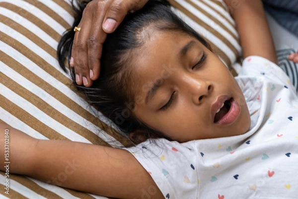 Obraz Child resting peacefully on a striped pillow
