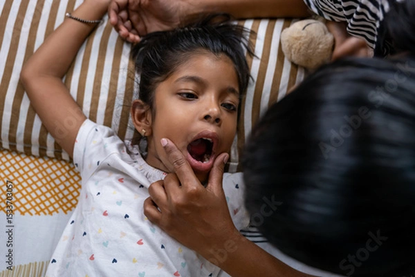 Obraz Child receives dental check-up at home during daytime
