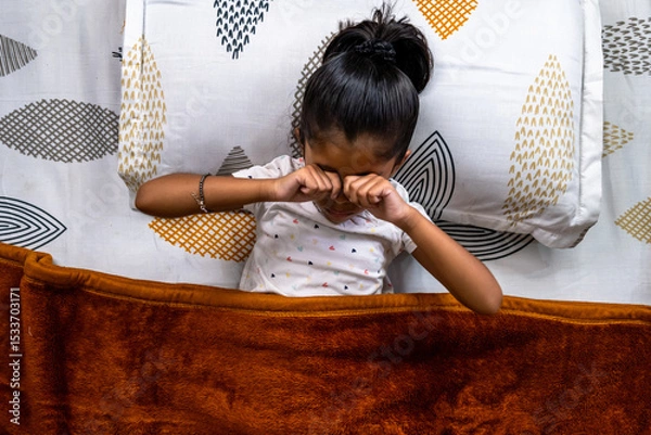Obraz Child waking up and rubbing eyes in cozy bed