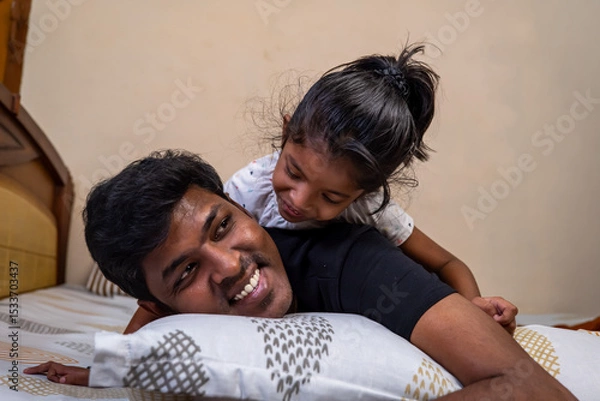 Obraz Father and daughter share a joyful moment at home