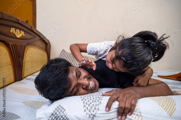 Obraz Father and daughter enjoying playful moment at home