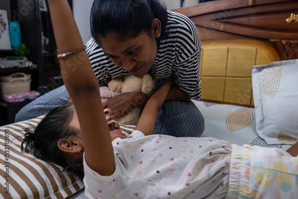 Obraz Mother and daughter enjoying playful bonding time indoors