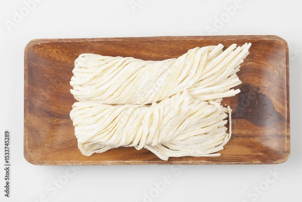 Fototapeta A food product made by kneading flour, buckwheat flour, potato flour, etc. and then stretching the dough into thin, long pieces by hand or machine.
