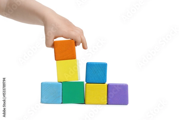 Fototapeta Child playing with colorful cubes on white background, closeup