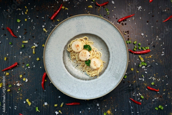 Fototapeta close up of a plate of pasta with scallops inside