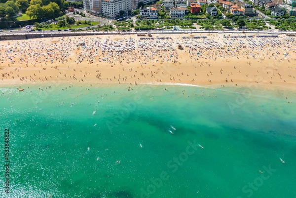 Fototapeta Aerial view of Ondarreta Beach with turquoise waters in San Sebastian or Donostia city, Basque Country, Spain