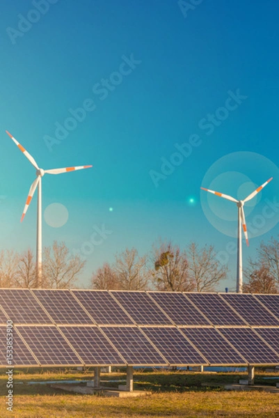 Fototapeta Industrial big solar power plant and wind turbines as universal green energy solution in Germany with direct sunlight and lens flare. Concept of energy and sustainable living.