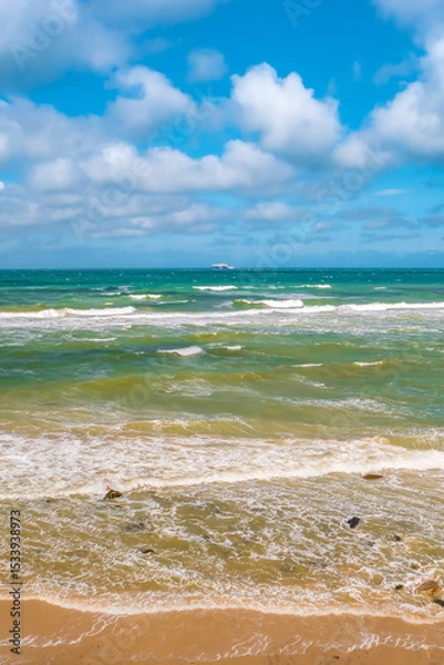 Fototapeta Cover page with a view of beach with clouds, blue sky and sea waves at summer sunny day