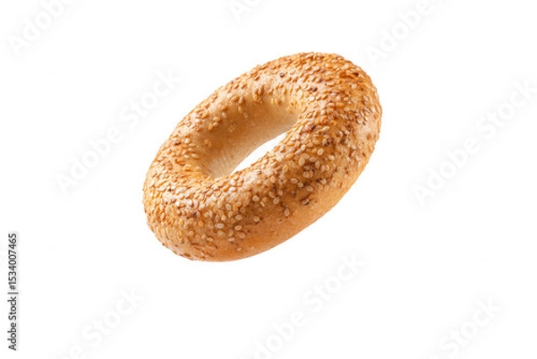 Fototapeta Fresh baked sesame bagel on a black background Closeup of a delicious, golden brown bagel sprinkled with sesame seeds Concept of breakfast, bakery, and food