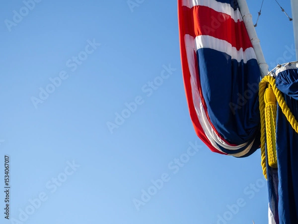 Obraz Flag of the United Kingdom with the colors of the nation red, white, blue. Abstact view of the flag with blue sky background
