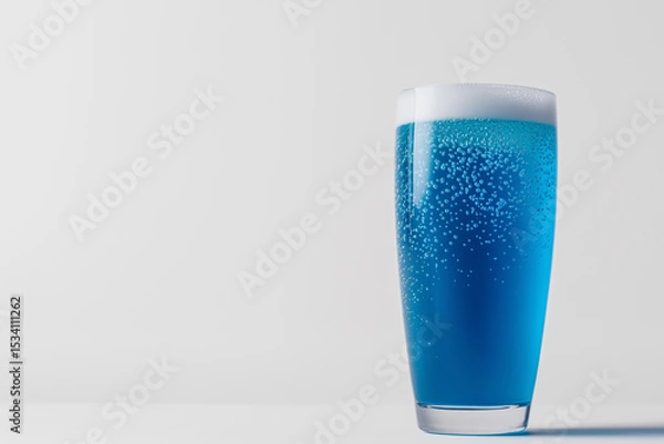 Obraz A vibrant blue energy drink in a sleek glass, effervescent bubbles rising inside, surrounded by minimal white space.