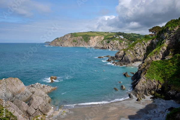 Obraz Paddleboarders on the water in Lee Bay seen from the South West Coast Path, North Devon