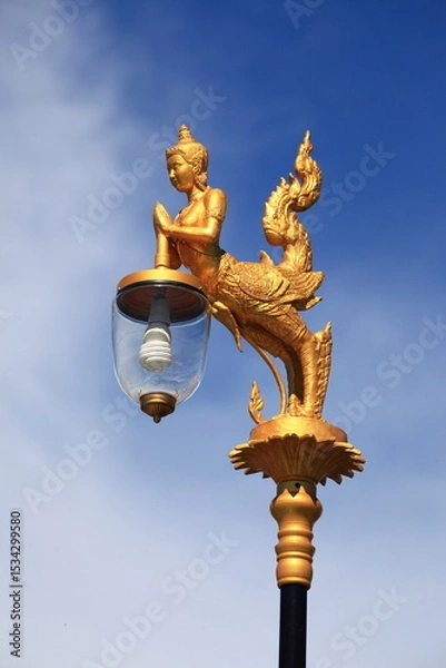 Fototapeta Kinaree is the animal in Thai myth. Street light in most important area uses Kinaree as a gold abstract sculpture lamp hanger.