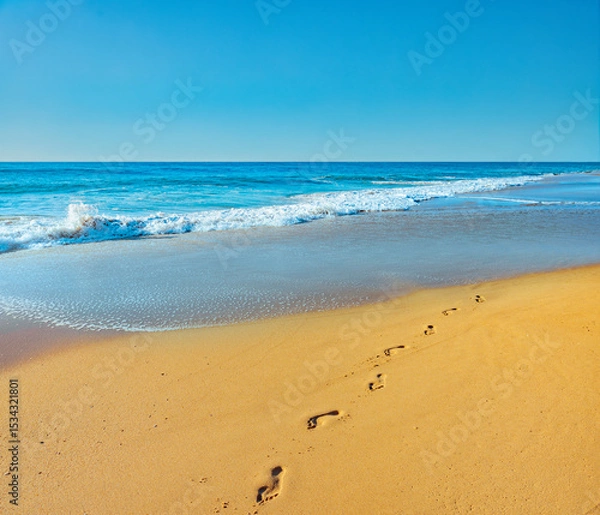 Obraz Fußsspuren im Sand an einem Goldenen Strand