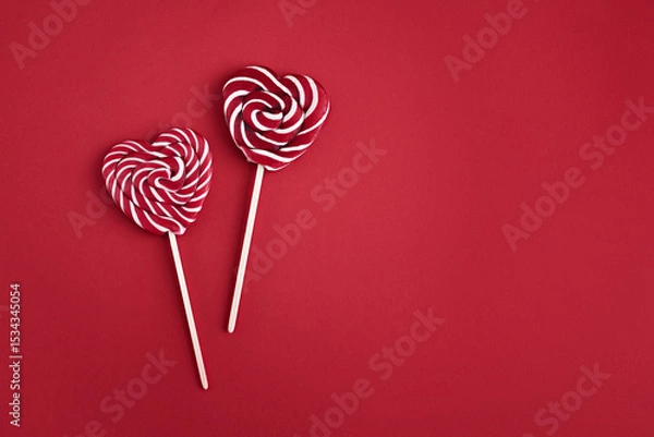 Fototapeta Heart lollipops candy on a stick on red background