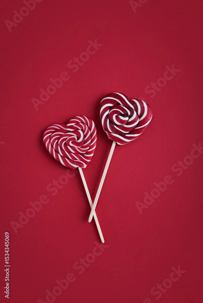 Fototapeta Heart lollipops candy on a stick on red background