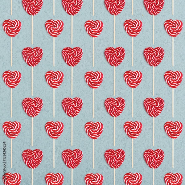 Fototapeta Pattern from heart lollipops candy on a stick on blue background